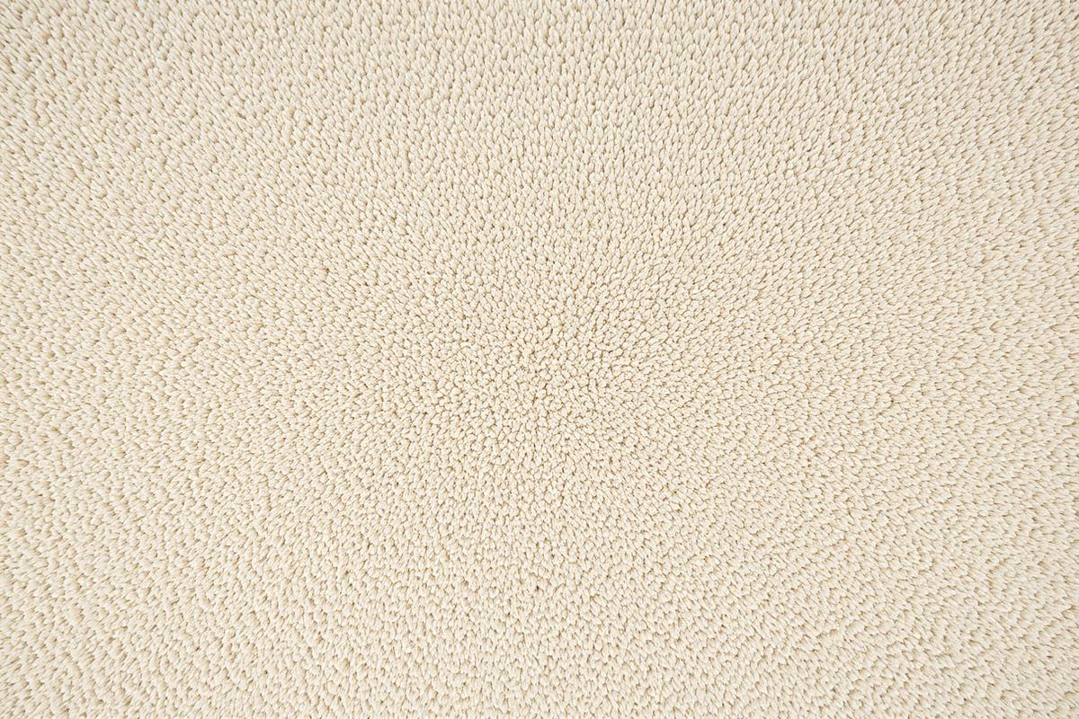 The same beige carpet clean and evenly toned after professional cleaning